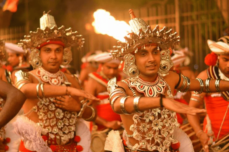 Traditional dancers are dancing in Kandy Esala Perahera